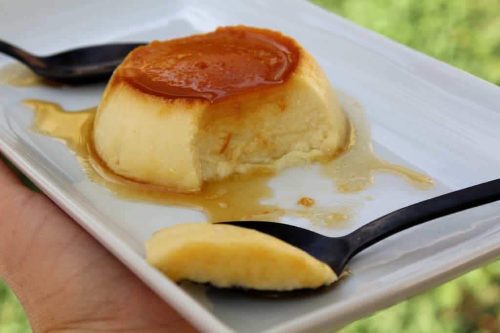 flan with a bite taken out on a spoon