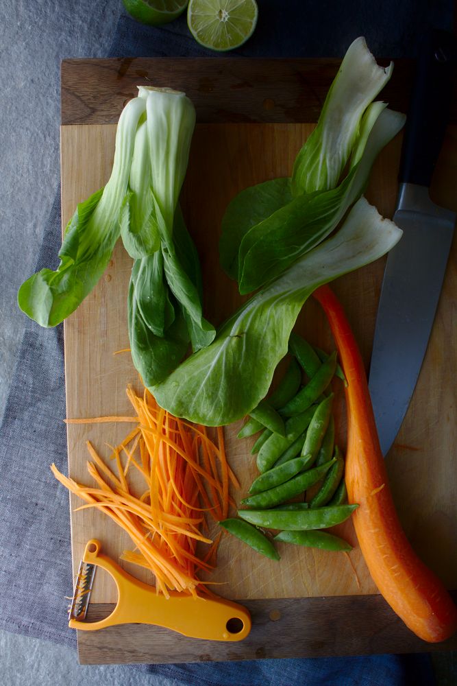 vegetables cut on cutting board with julienne peeler