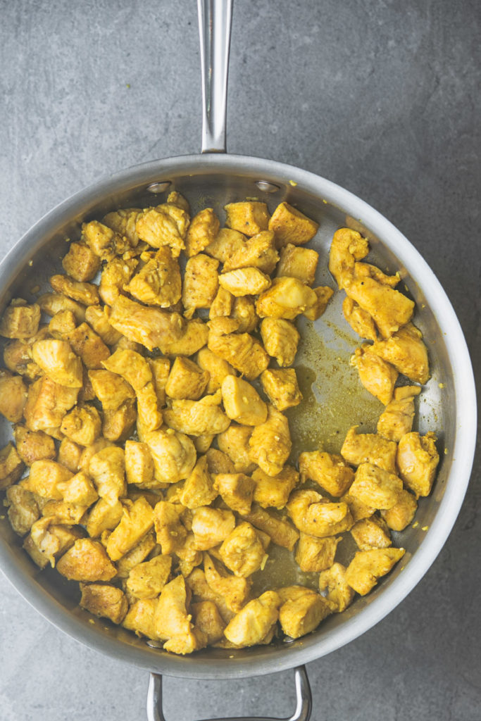 curry seasoned chicken in a skillet
