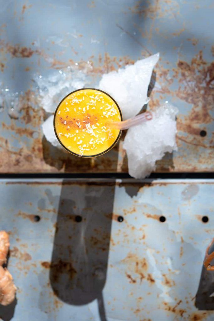 tropical smoothie in a glass with cinnamon and coconut