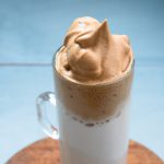 Dalgona coffee foam with honey over almond milk