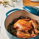 whole roast chicken over radishes in Dutch oven