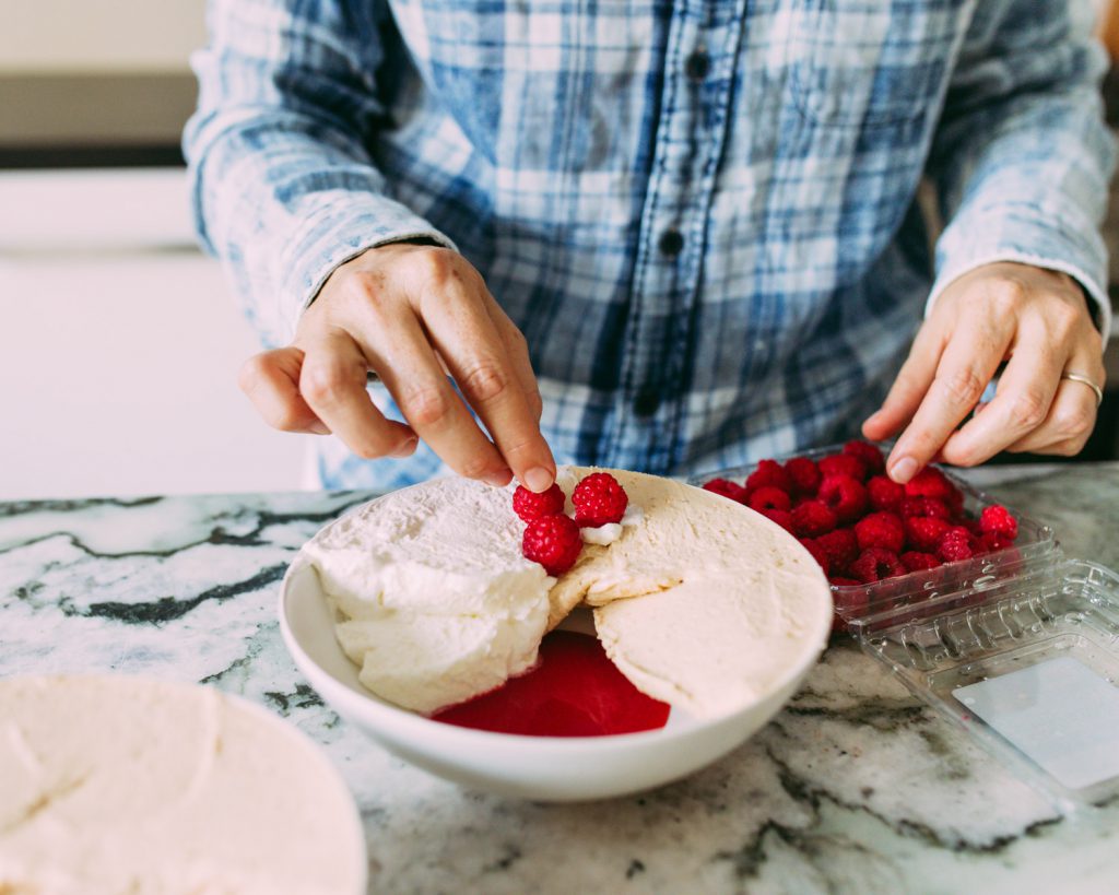 garnishing with fresh raspberries